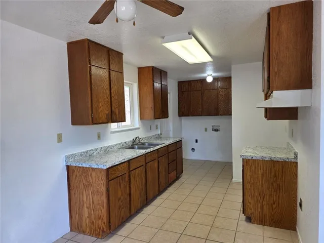 a kitchen with a sink window and cabinets
