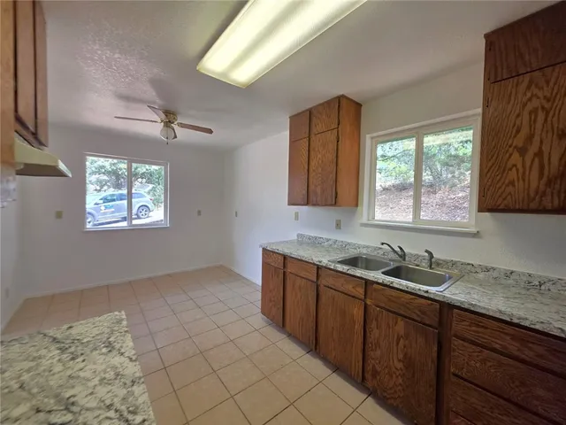 a spacious bathroom with a granite countertop sink and a mirror
