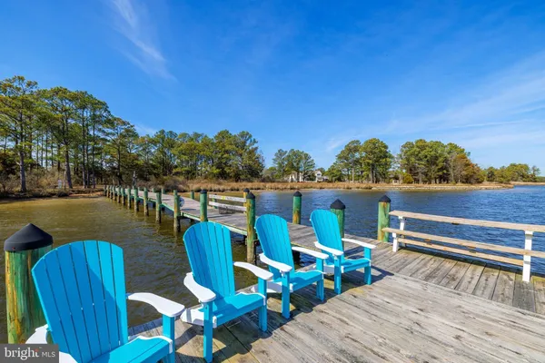 a view of a deck with chairs and wooden floor