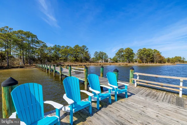 a view of a deck with chairs and wooden floor