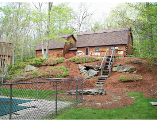 39 Casey Road Spencer, MA 01562 - Photo 1 of 22 a view of a house with wooden fence next to a yard