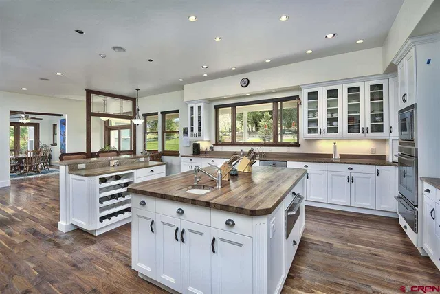 a kitchen with granite countertop a sink stove and cabinets