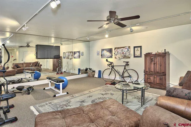 a living room with furniture a air conditioner and a window