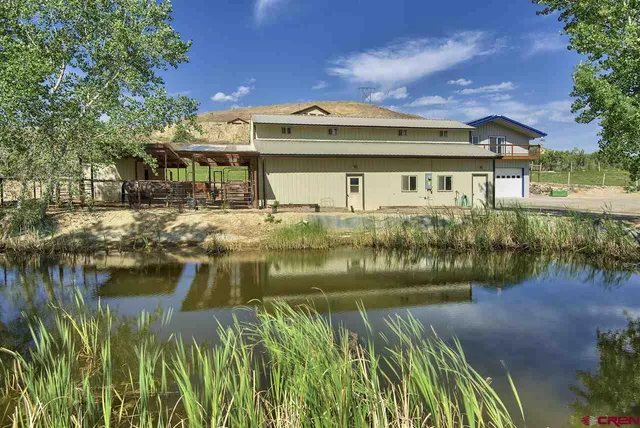 a front view of a house with a lake view