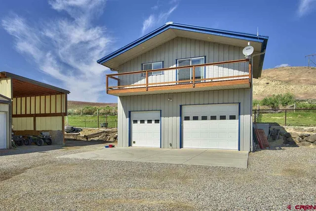 a front view of a house with a road