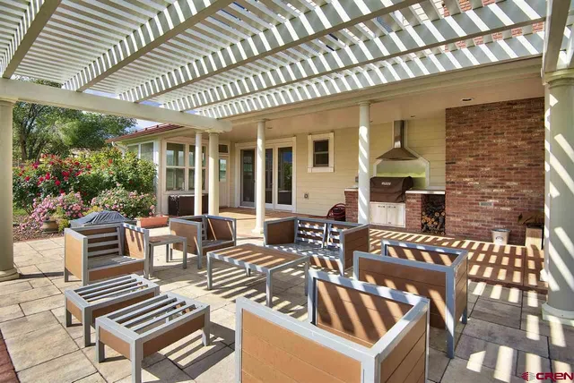 a view of a patio with couches table and chairs and potted plants