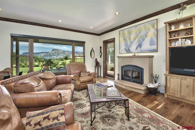 a living room with furniture a flat screen tv and a fireplace