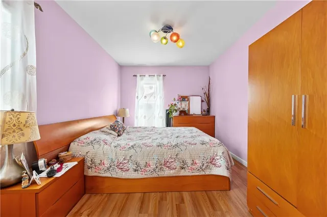 a bed room with a bed and a chair