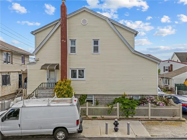 a car parked in front of a white house