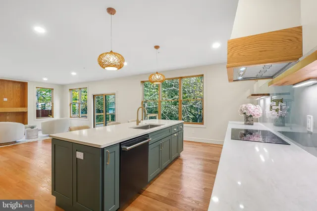 a kitchen with a sink cabinets and wooden floor
