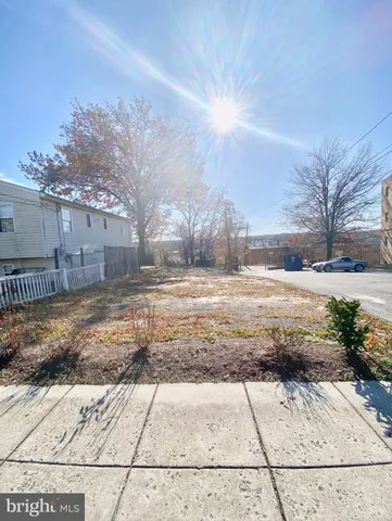 a view of a yard with wooden fence