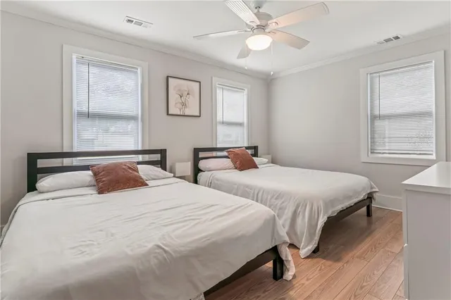 a bedroom with two beds and a window
