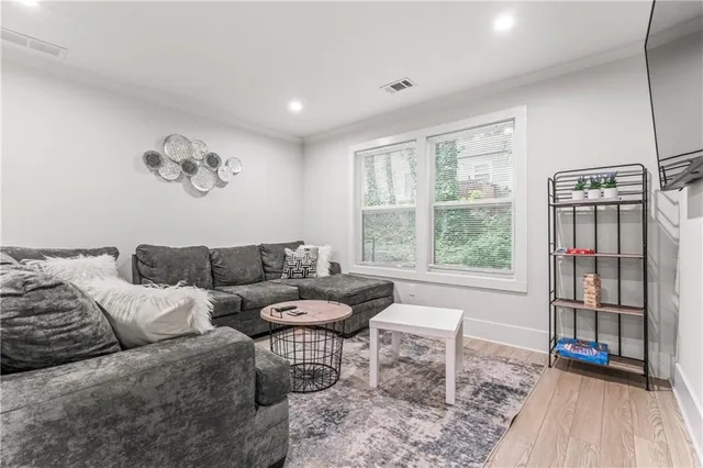 a view of a livingroom with furniture window and wooden floor