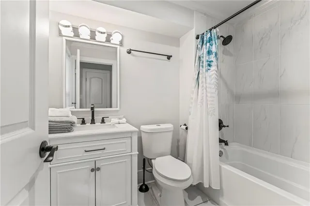 a bathroom with a sink vanity toilet and a mirror