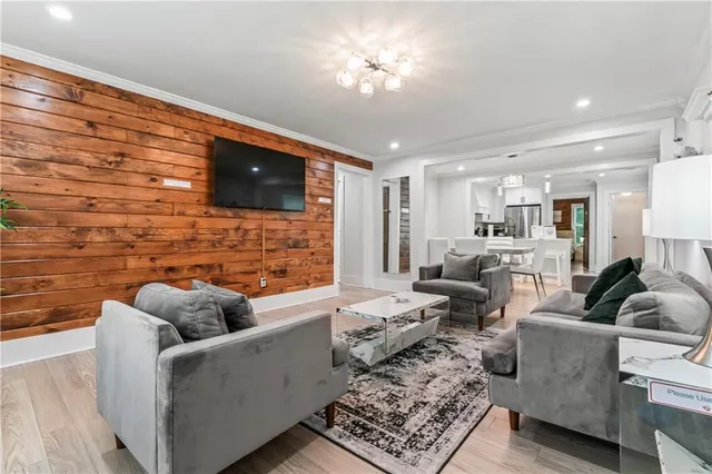 a living room with furniture and wooden floor
