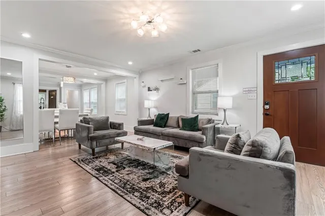 a living room with furniture and a chandelier