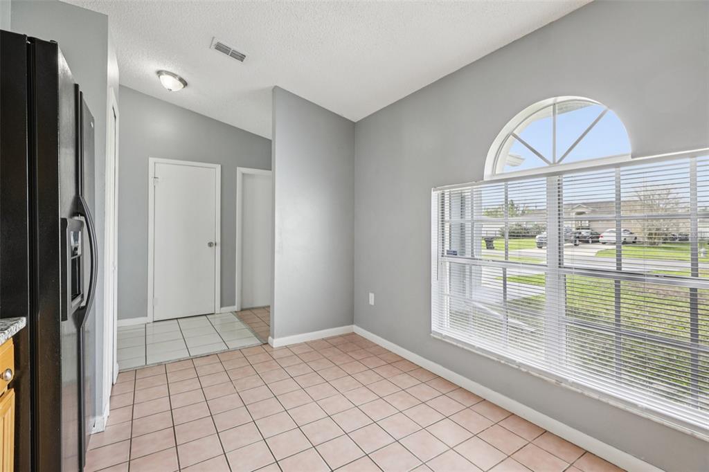 734 Bittern Lane Kissimmee, FL 34759 - Photo 13 of 55 a view of empty room with wooden floor and fan