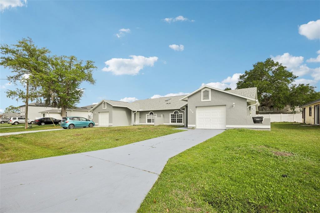 734 Bittern Lane Kissimmee, FL 34759 - Photo 2 of 55 a front view of a house with a yard and garage