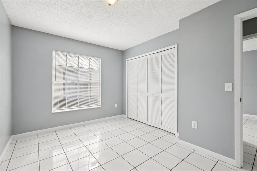 734 Bittern Lane Kissimmee, FL 34759 - Photo 23 of 55 a view of an empty room with window and cabinet area