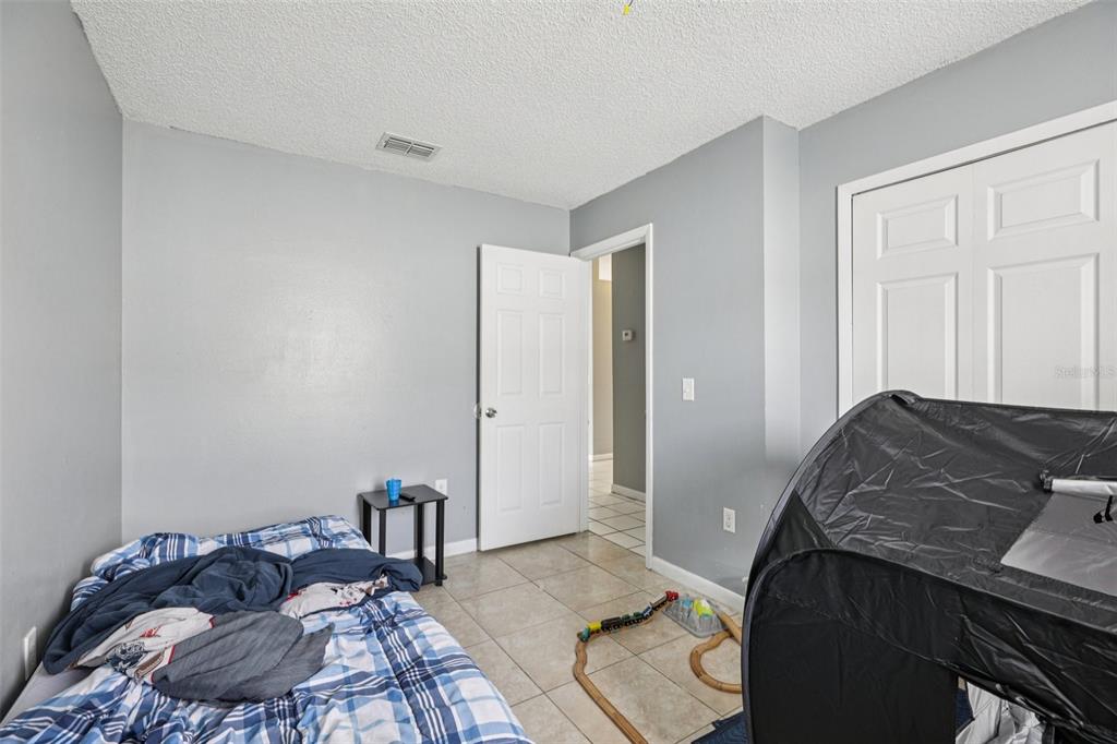 734 Bittern Lane Kissimmee, FL 34759 - Photo 38 of 55 a bedroom with a bed and a window