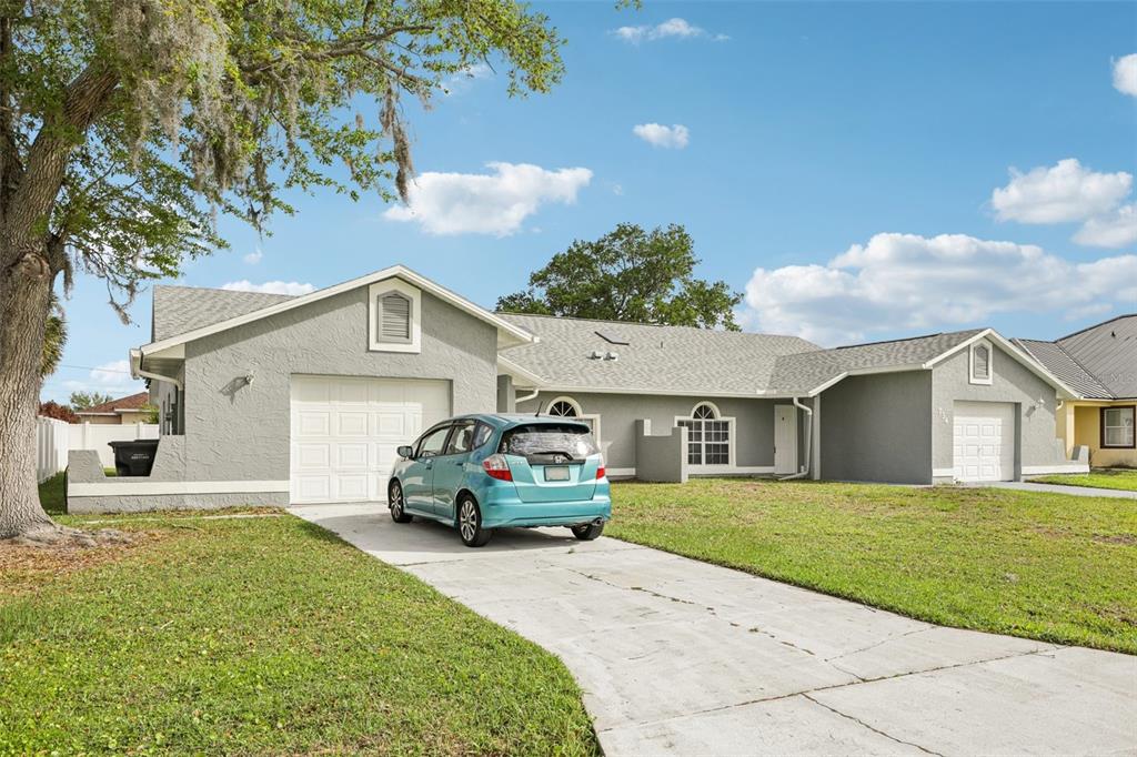734 Bittern Lane Kissimmee, FL 34759 - Photo 4 of 55 a car parked in front of white house