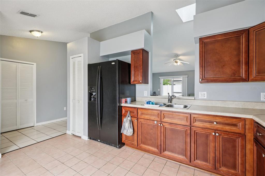 734 Bittern Lane Kissimmee, FL 34759 - Photo 46 of 55 a kitchen with stainless steel appliances granite countertop a refrigerator and a sink