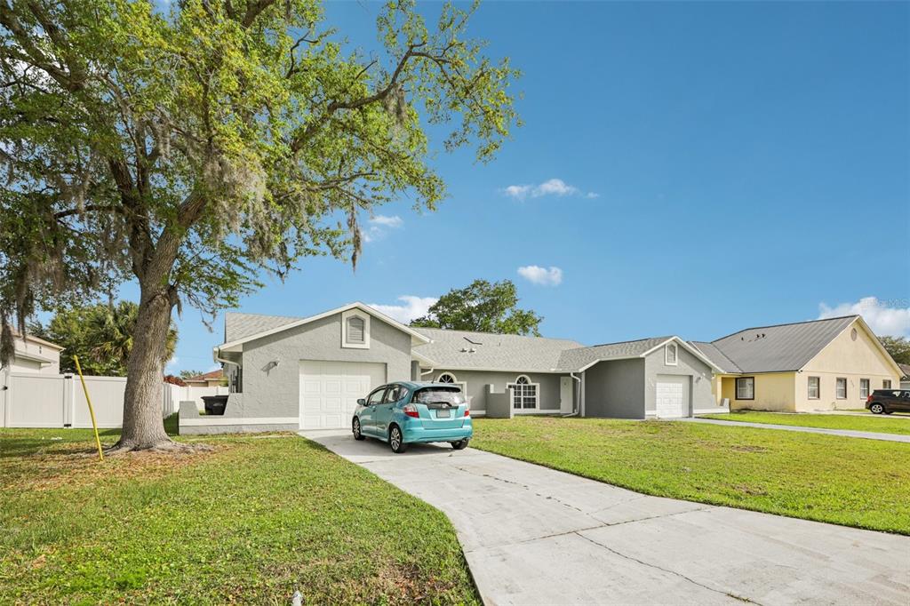 734 Bittern Lane Kissimmee, FL 34759 - Photo 5 of 55 a front view of a house with a yard and garage