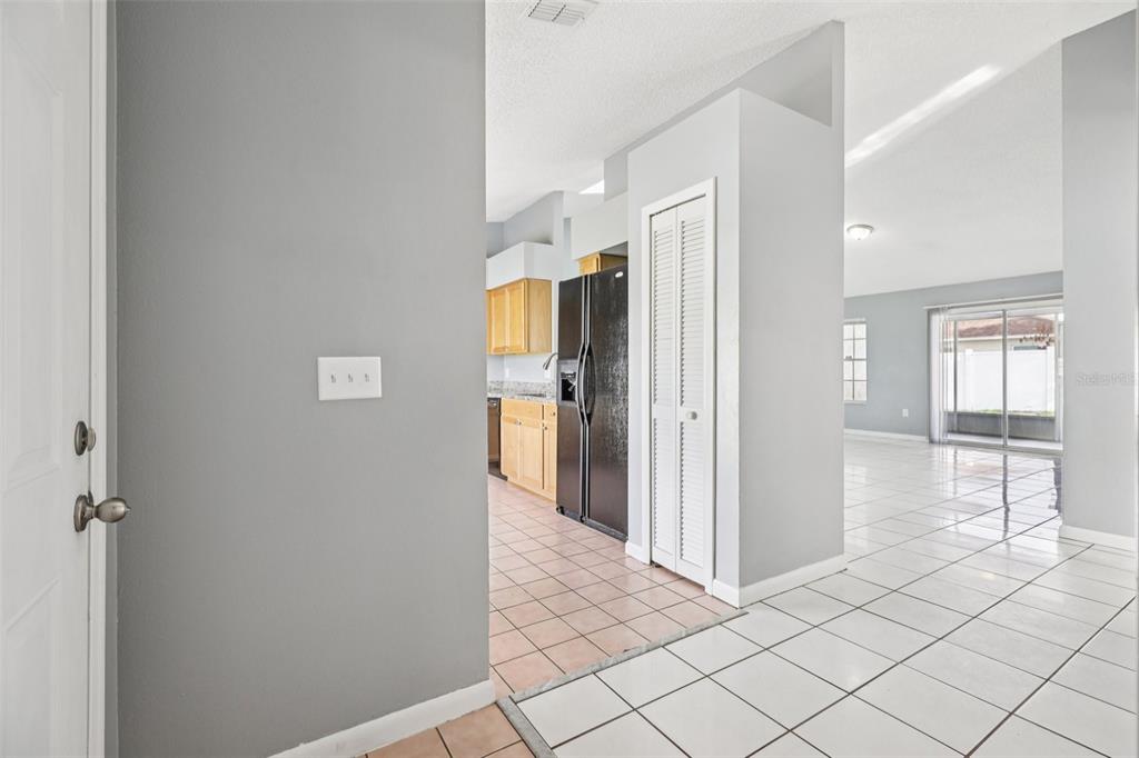734 Bittern Lane Kissimmee, FL 34759 - Photo 6 of 55 a view of a livingroom with wooden floor and a refrigerator