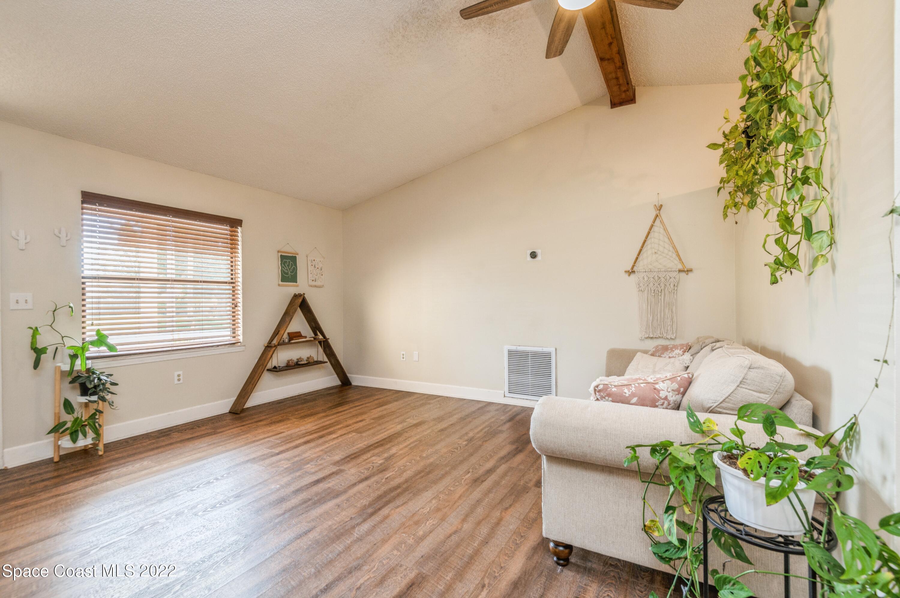 6480 Hudson Road Cocoa, FL 32927 - Photo 4 of 24 a living room with furniture and a potted plant