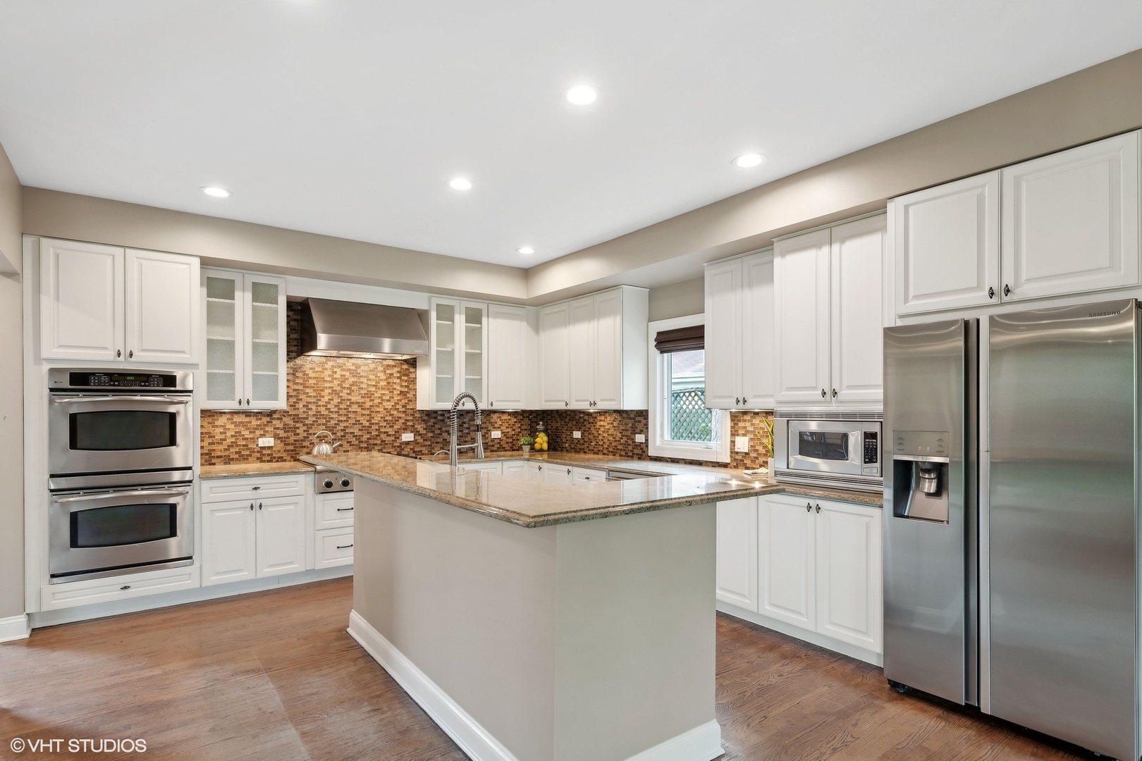 423 Sumac Road Highland Park, IL 60035 - Photo 7 of 31 a kitchen with kitchen island a sink and white stainless steel appliances