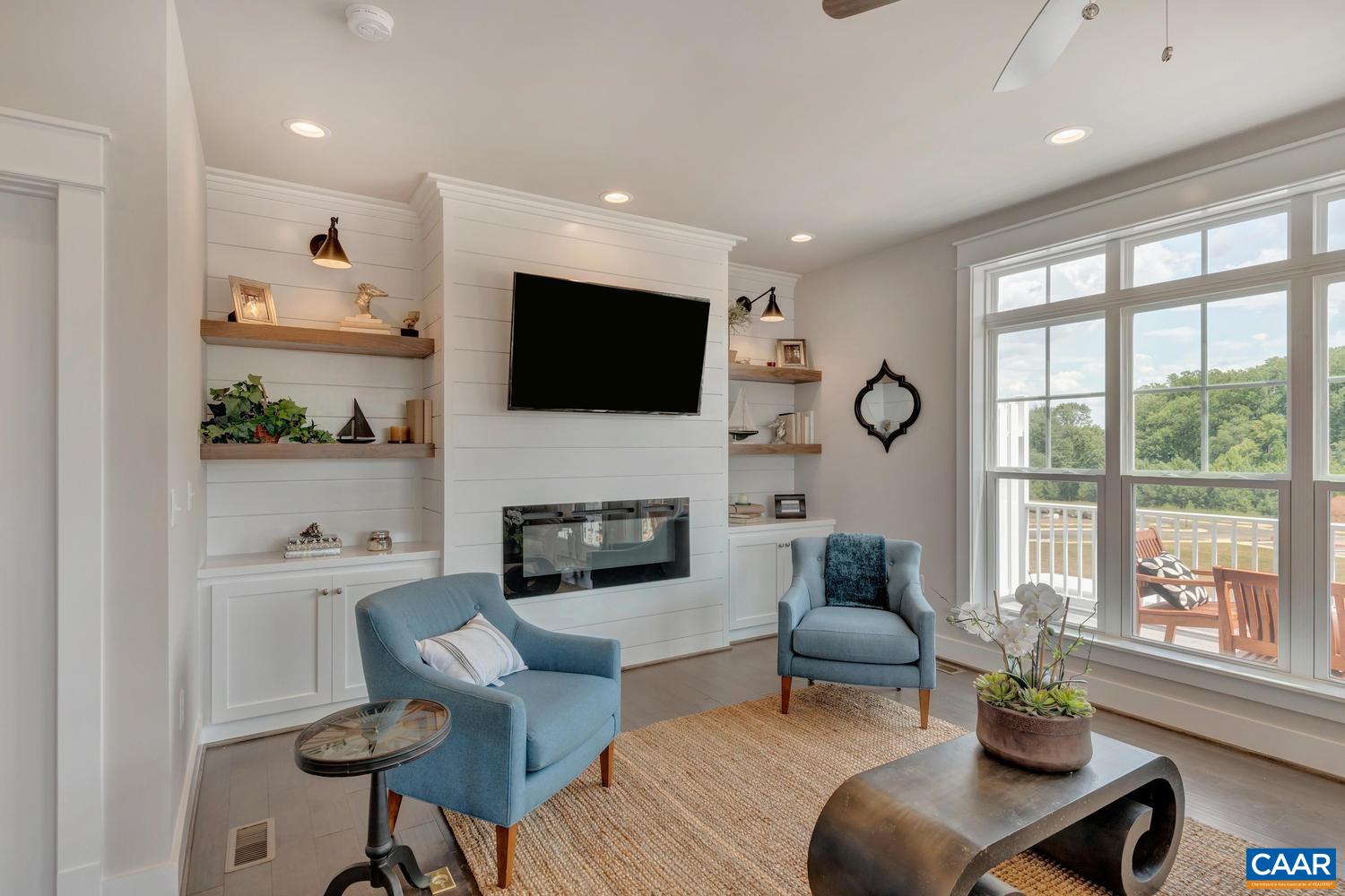 3518 Rowcross Street Crozet, VA 22932 - Photo 17 of 50 a living room with furniture a fireplace and a flat screen tv