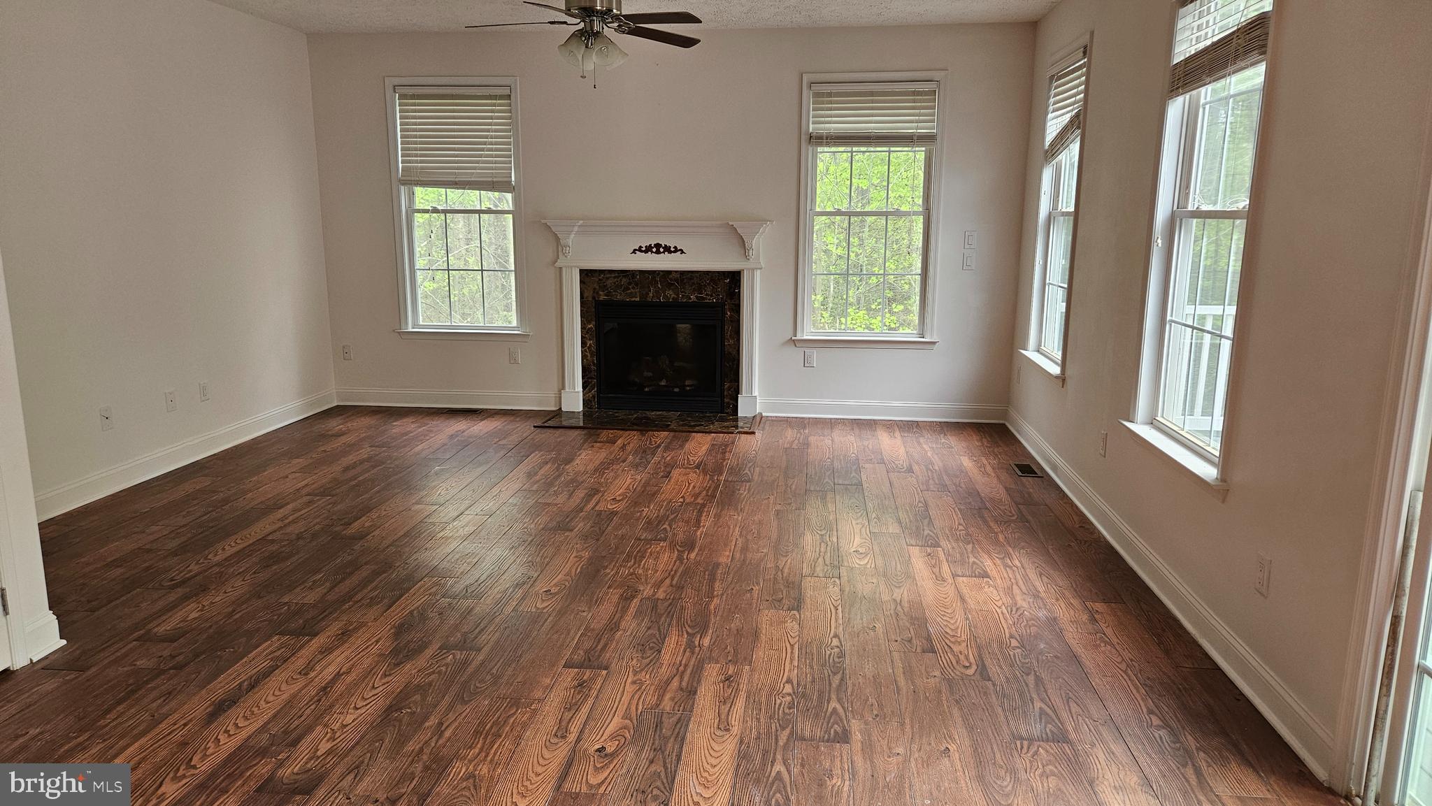 10495 Green Leaf Place La Plata, MD 20646 - Photo 7 of 24 an empty room with wooden floor a fireplace and windows