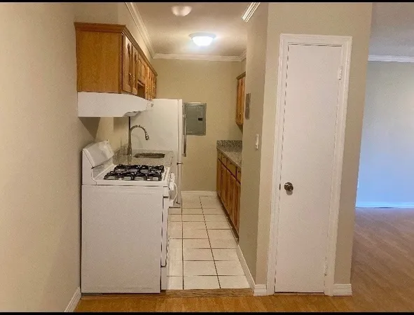 a kitchen with a refrigerator and cabinets