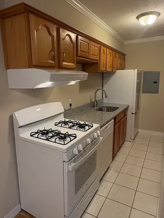 a stove top oven sitting inside of a kitchen