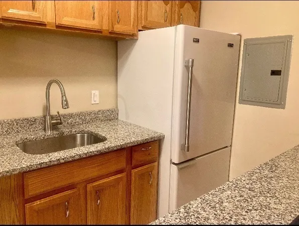 a kitchen with a refrigerator and a sink