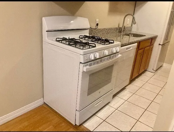 a stove top oven sitting inside of a kitchen