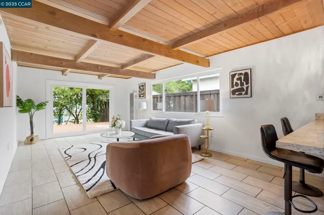 a view of hallway with furniture and a window