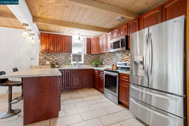 a kitchen with stainless steel appliances granite countertop a sink and cabinets