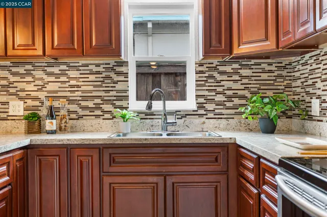 a kitchen with stainless steel appliances granite countertop a stove microwave and refrigerator