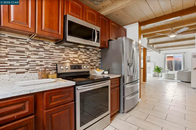 a bedroom with a bed and painting on the wall