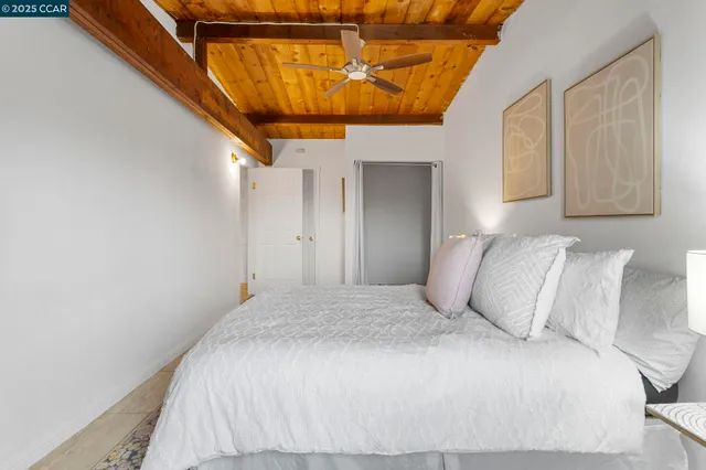 a bedroom with a bed and a potted plant