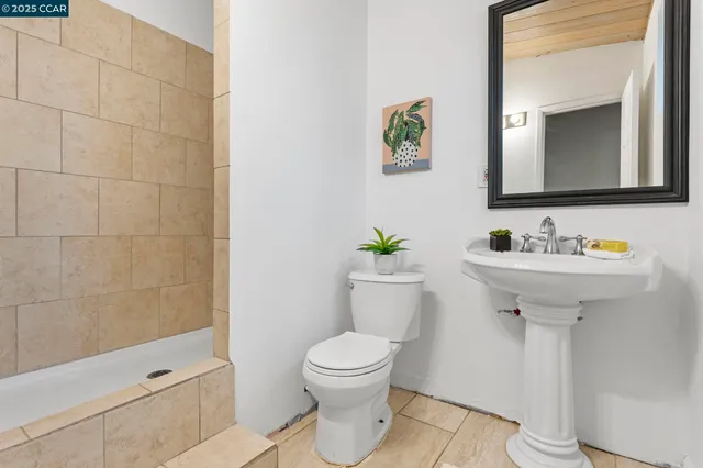 a bed room with a bed and a painting on the wall