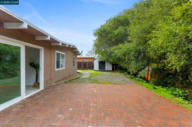 a view of backyard with a garden and pathway