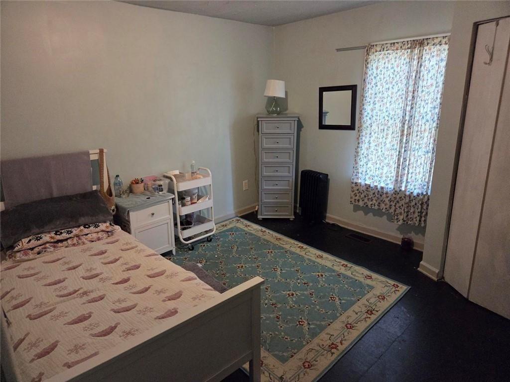 3790 Mauck Street Clarkston, GA 30021 - Photo 22 of 26 a bedroom with a bed and wooden floor