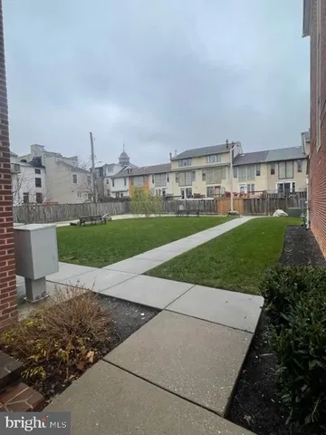 a view of a house with backyard and deck