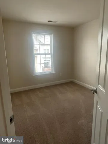 a front view of a residential apartment building with a yard