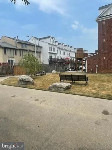 a front view of a house with a yard and plants