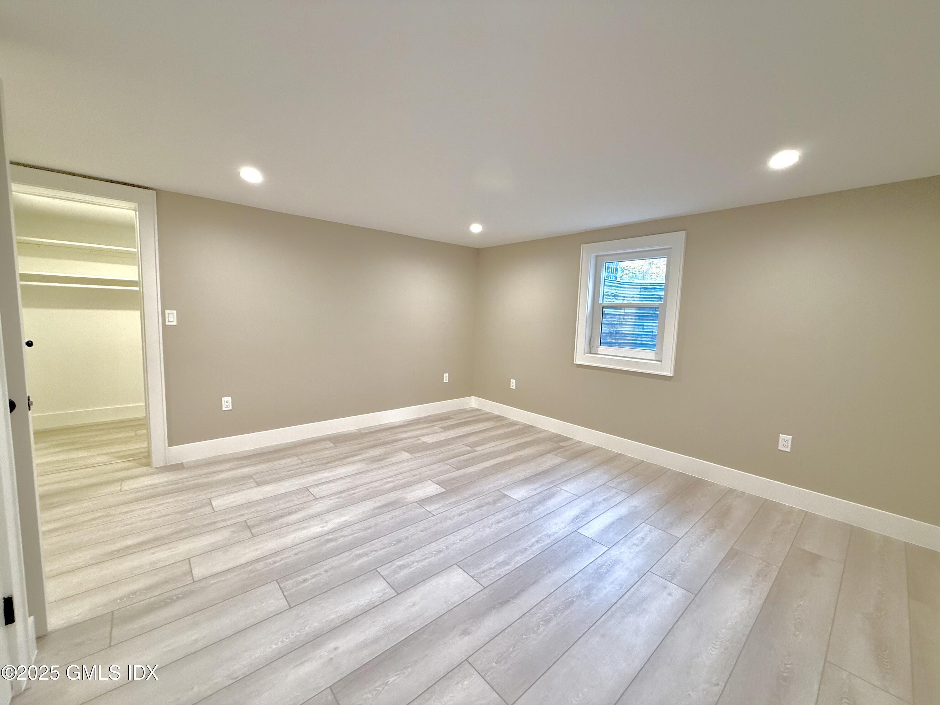 79 Laddins Rock Road Old Greenwich, CT 06870 - Photo 16 of 26 a view of empty room with wooden floor and fan