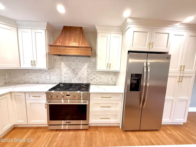 a kitchen with granite countertop a stove and a refrigerator