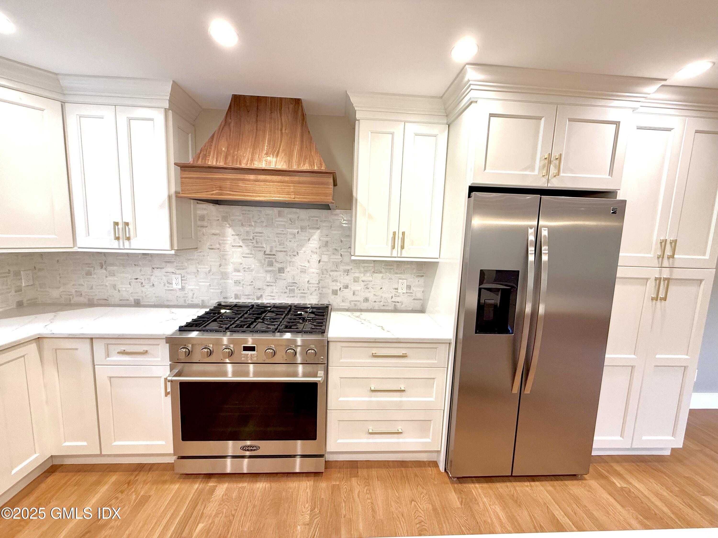 79 Laddins Rock Road Old Greenwich, CT 06870 - Photo 4 of 26 a kitchen with granite countertop a stove and a refrigerator
